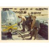 This is getting ready for a team outing (mission) with the minigun. Its in the revetment in the valley between 2/17th area and out D/1/1 Cav area. That's (L to R) Sgt. Pelkey getting the firing mechanism set on the gun, the pilot who I can't recognize, Sp4 Ken Christol (who got wounded later on and was sent home, later to go to flight school and come back as a helicopter pilot) and Sp4 Blouin, who flew left seat observer and could fly the chopper as well as the pilot.